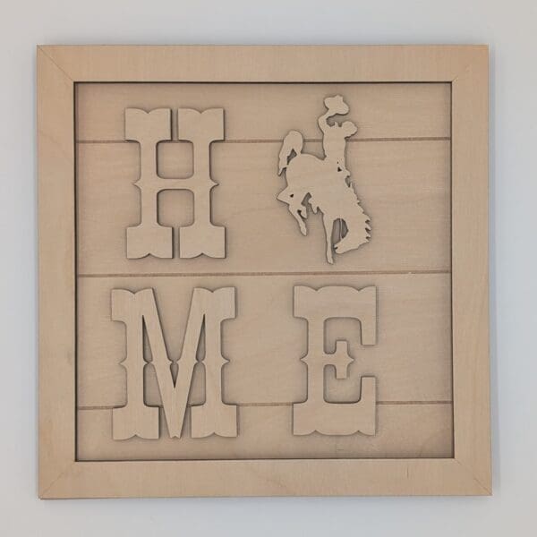 Red Rooster Laser Arts The DIY Small Wooden Steamboat Home Sign features wooden wall art that spells HOME, replacing the O with a cutout steamboat silhouette. This square wood frame has a light natural finish and is inspired by our bee-themed DIY sign kit.