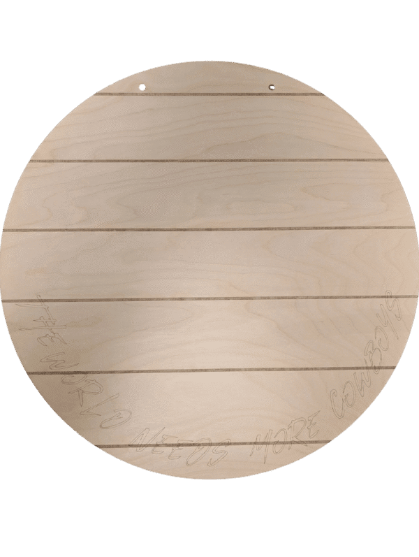 Red Rooster Laser Arts The DIY Door Hanger Kit - University of Wyoming Pride features a round, light wood sign with horizontal engraved lines, subtle bottom text reading THE WORLD NEEDS MORE COWBOYS, and two holes for easy hanging—perfect for any space.