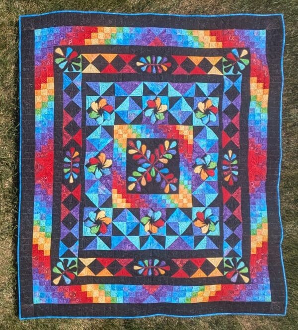 A colorful quilt with a star design on it.