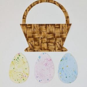 A basket with three different colored eggs on it.