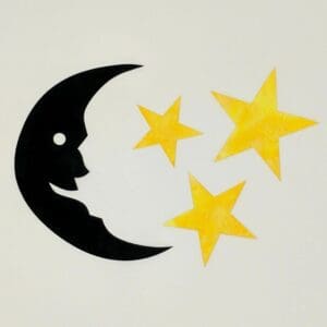 A black and white moon with yellow stars on the side.