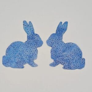 Two blue rabbits sitting next to each other.