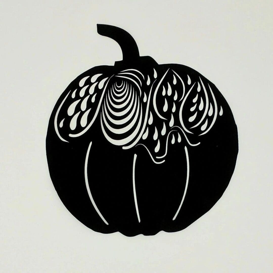 A black and white pumpkin with a design on it.