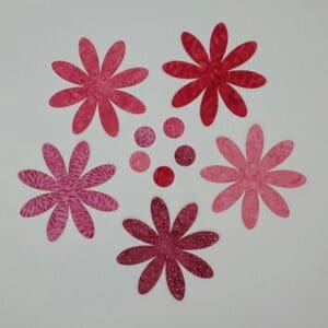 A group of pink flowers sitting on top of a table.