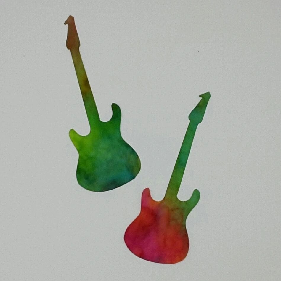 Two guitars are painted green and red.