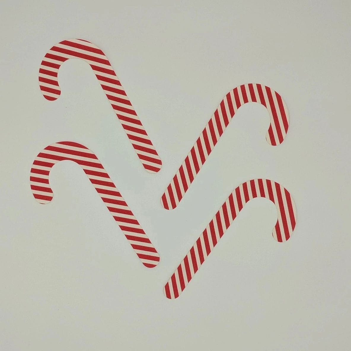 A group of candy canes that are on the wall.