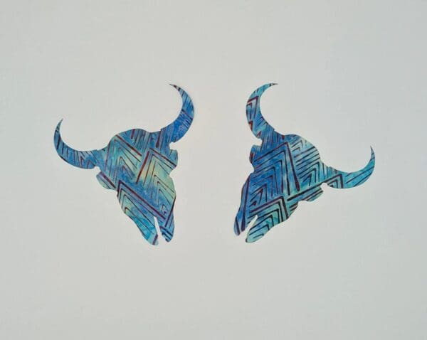 A pair of blue animal horns with a white background