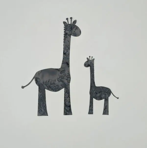 A couple of giraffes are standing next to each other