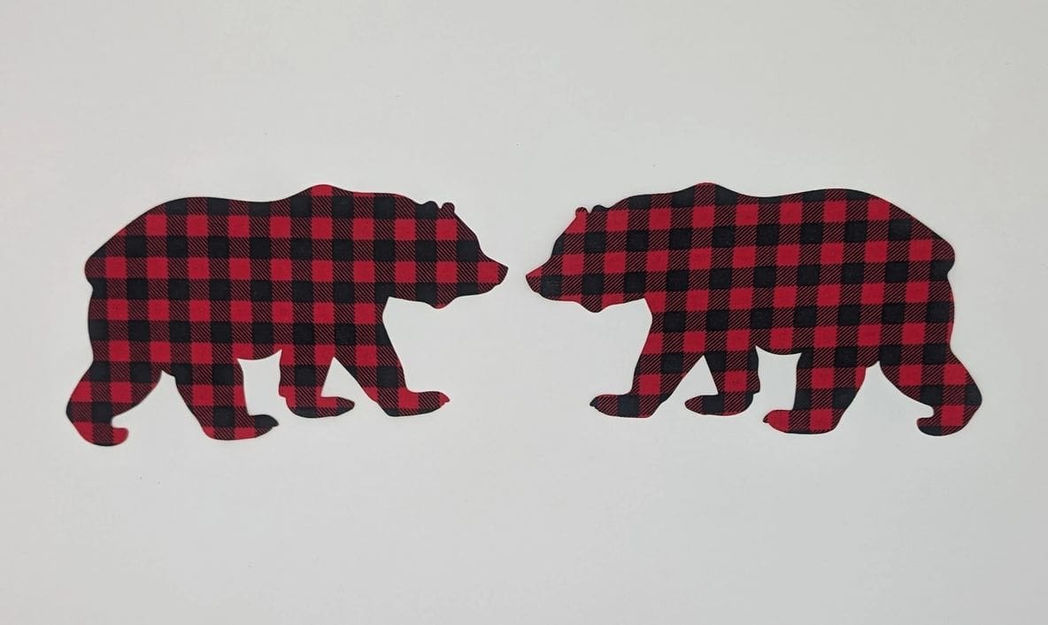 Two bears are facing opposite directions in a plaid pattern.