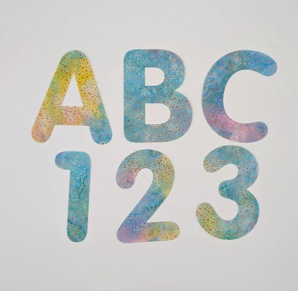 A set of letters and numbers painted with pastel colors.