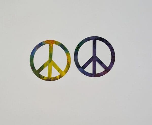 Two peace signs are shown in a rainbow color.