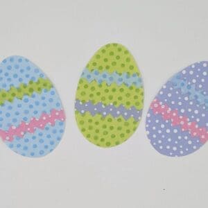 Three eggs with different designs on them.