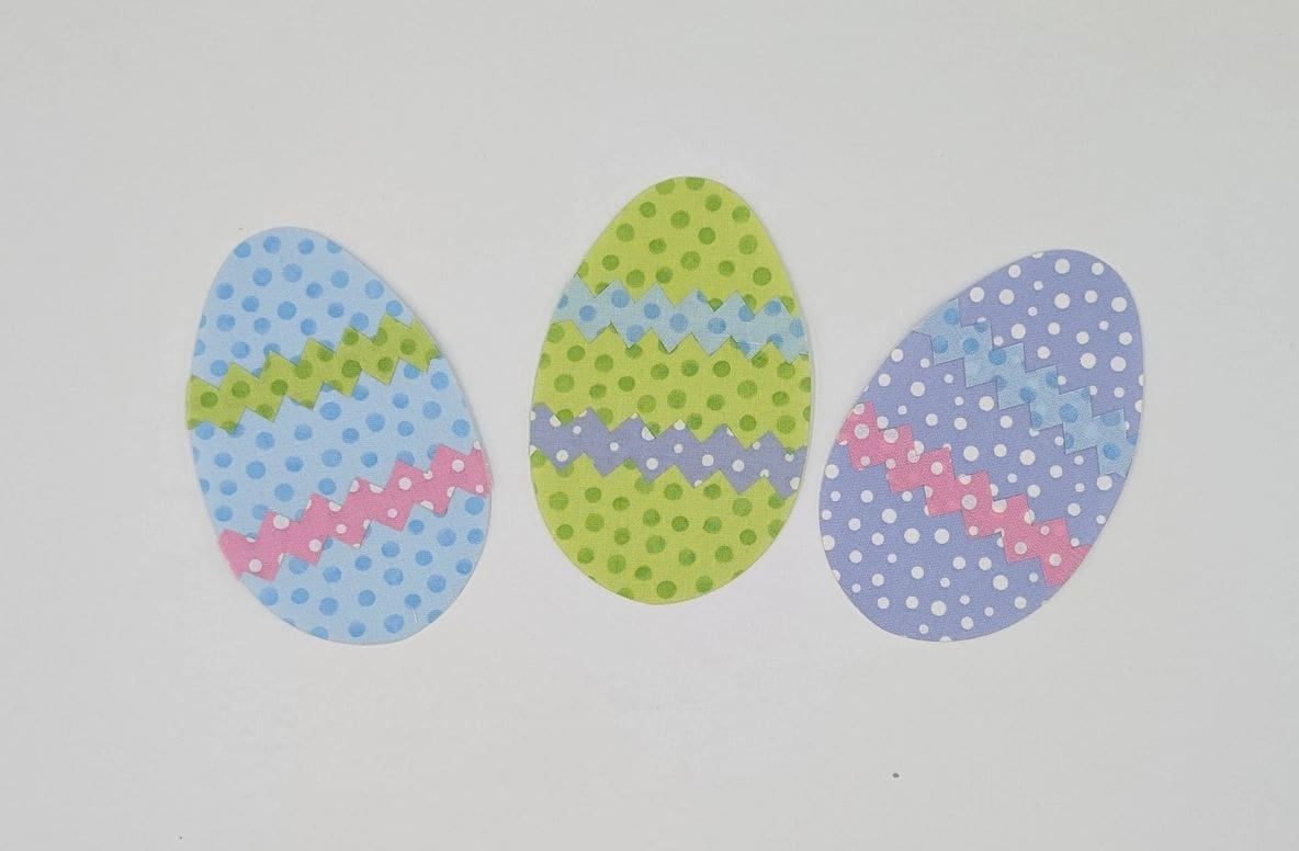 Three eggs with different designs on them.