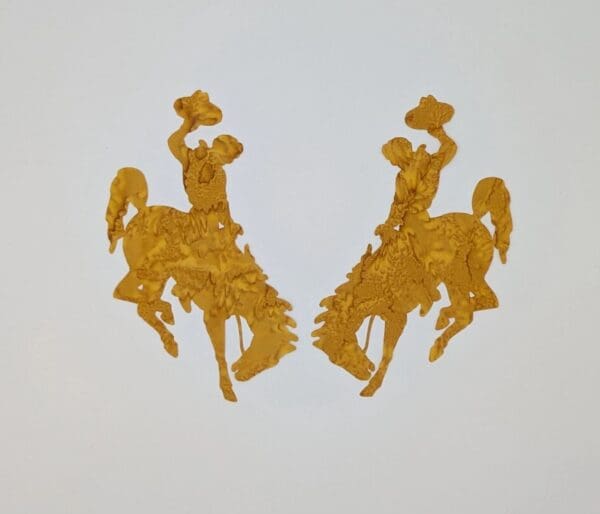 A pair of gold bucking horse magnets.