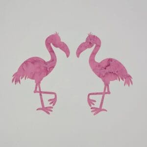 A pair of pink flamingos are standing next to each other.