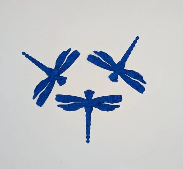 Three blue dragonflies are shown in a circle.