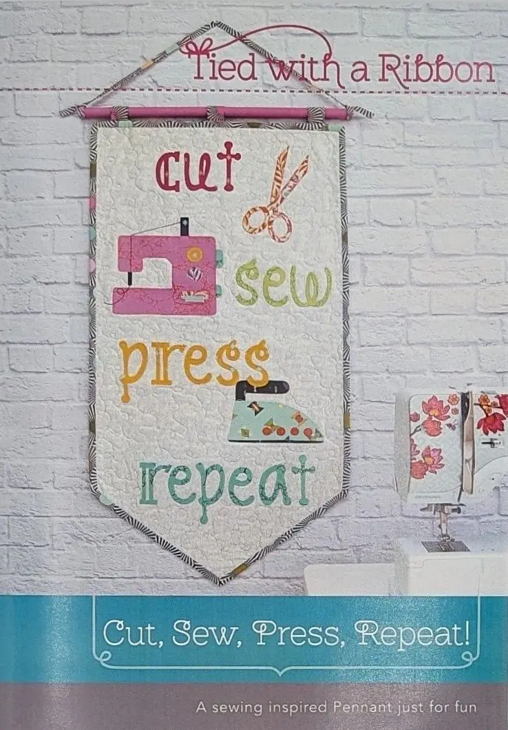 A banner hanging on the wall with sewing themed words.