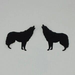 A pair of black wolf earrings on white background.