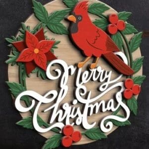 Red Rooster Laser Arts The DIY Door Hanger Kit - Christmas Cabin (Copy) features a round wooden sign with a red cardinal, poinsettia, holly leaves, berries, and "Merry Christmas" in white script—ideal for festive holiday decor!.