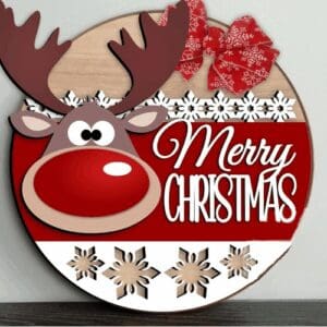 Red Rooster Laser Arts The DIY Door Hanger Kit - Merry Christmas Reindeer features a round wooden sign with a cartoon reindeer, big eyes, white snowflakes, red background and bow, plus “Merry Christmas” in white letters.