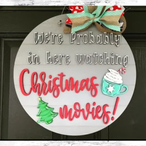 Red Rooster Laser Arts The DIY Door Hanger Kit - Watching Christmas Movies features a round sign with "We're Probably in here watching Christmas movies!", a green tree, mug with whipped cream, bow, and left panel reading Christmas Door Hanger and LASER SVG FILES. Perfect for your DIY project!.