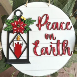 Red Rooster Laser Arts Round wooden door hanger featuring a red candle in a lantern, poinsettia flower, and "Peace on Earth" in red script. Perfect for your DIY project using the DIY Door Hanger Kit - Peace. LASER SVG FILE by Lula Bean Design Co.
