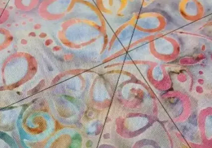 Pastel batik fabric, quilting lines.